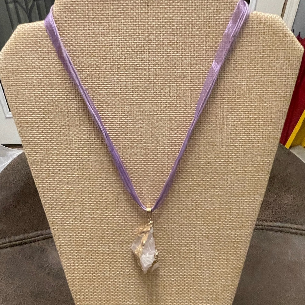 Lavender hued crystal on purple cord